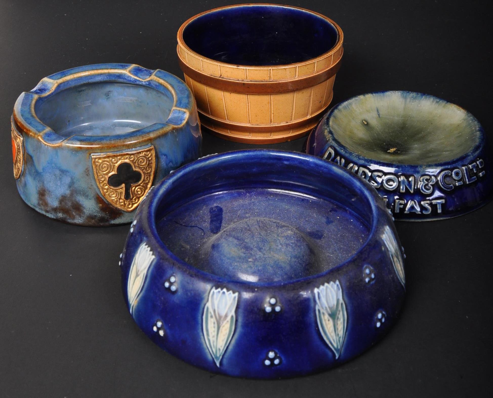 FOUR EARLY 20TH CENTURY ROYAL DOULTON POTTERY ASHTRAYS