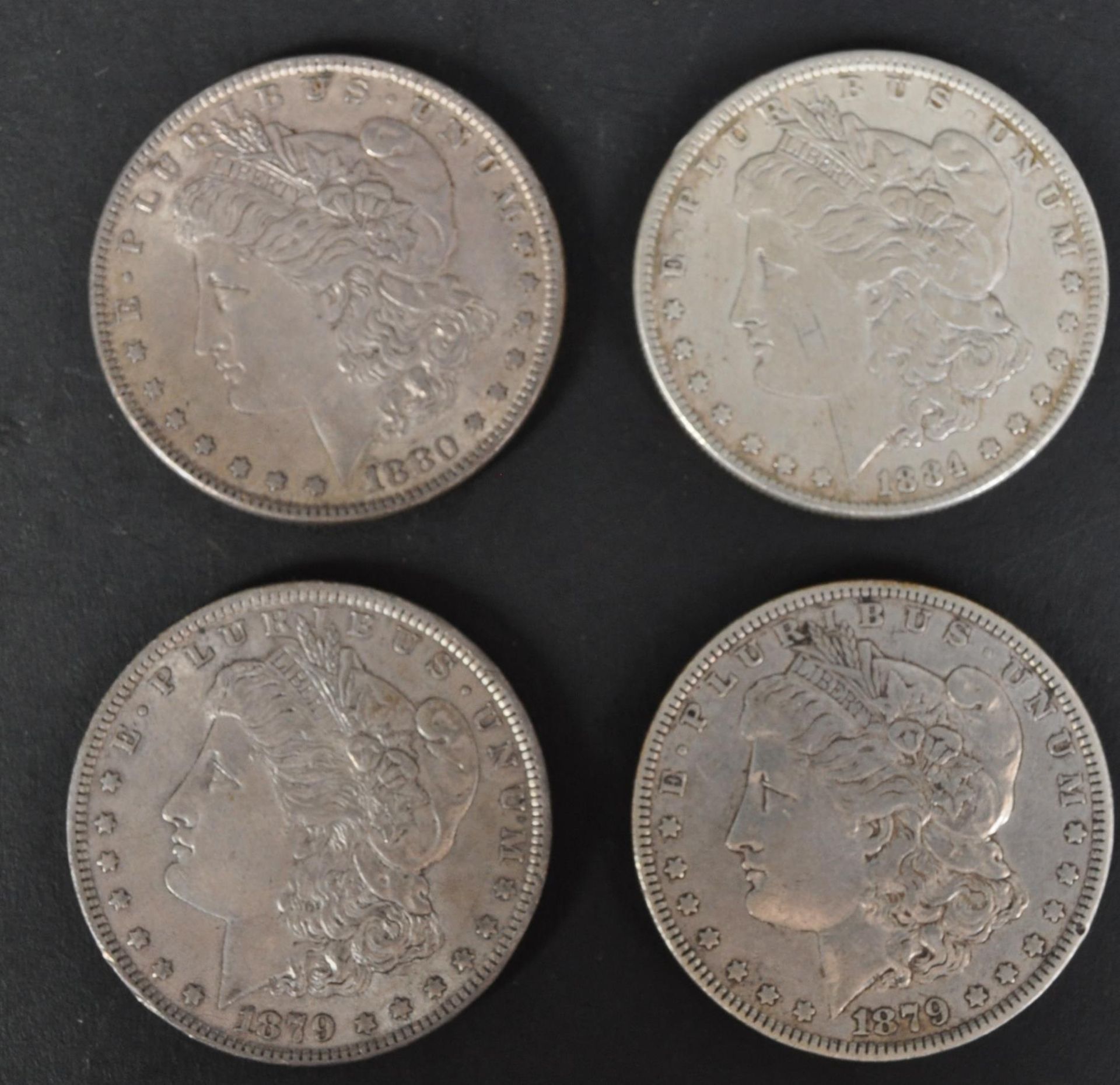 FOUR 19TH CENTURY AMERICAN SILVER MORGAN DOLLAR COINS