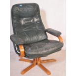 Retro 20th century green leather and bentwood swivel armchair. Raised on splayed leg base with