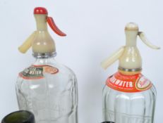 COLLECTION OF SODA SYPHONS & GREEN PUB BOTTLES