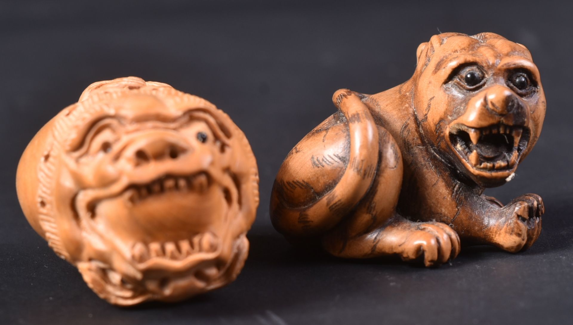 TWO JAPANESE CARVED WOODEN TIGER NETSUKES