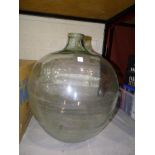 A glass carboy, 49cm high and a collection of coloured glass ware including vases, bowls, etc.