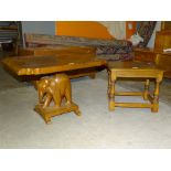 An Ercol dark elm stool/table, 46 x 36cm, 38cm high and an occasional table with carved elephant