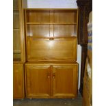 A modern Ercol light elm cabinet/shelves unit, the upper section fitted with a shelf above, on