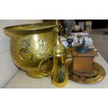 A brass jardinière with lion-mask handles and embossed decoration of a coat of arms - a knight's