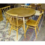 An Ercol circular dining table, 89cm diameter and four chairs.