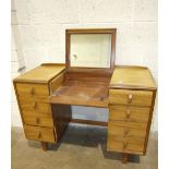 A mid-20th century knee-hole dressing table with folding mirror and eight drawers, 107cm wide, a