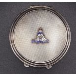 A Royal Artillery silver circular compact, the engine-turned lid with RA insignia, 66mm diameter,