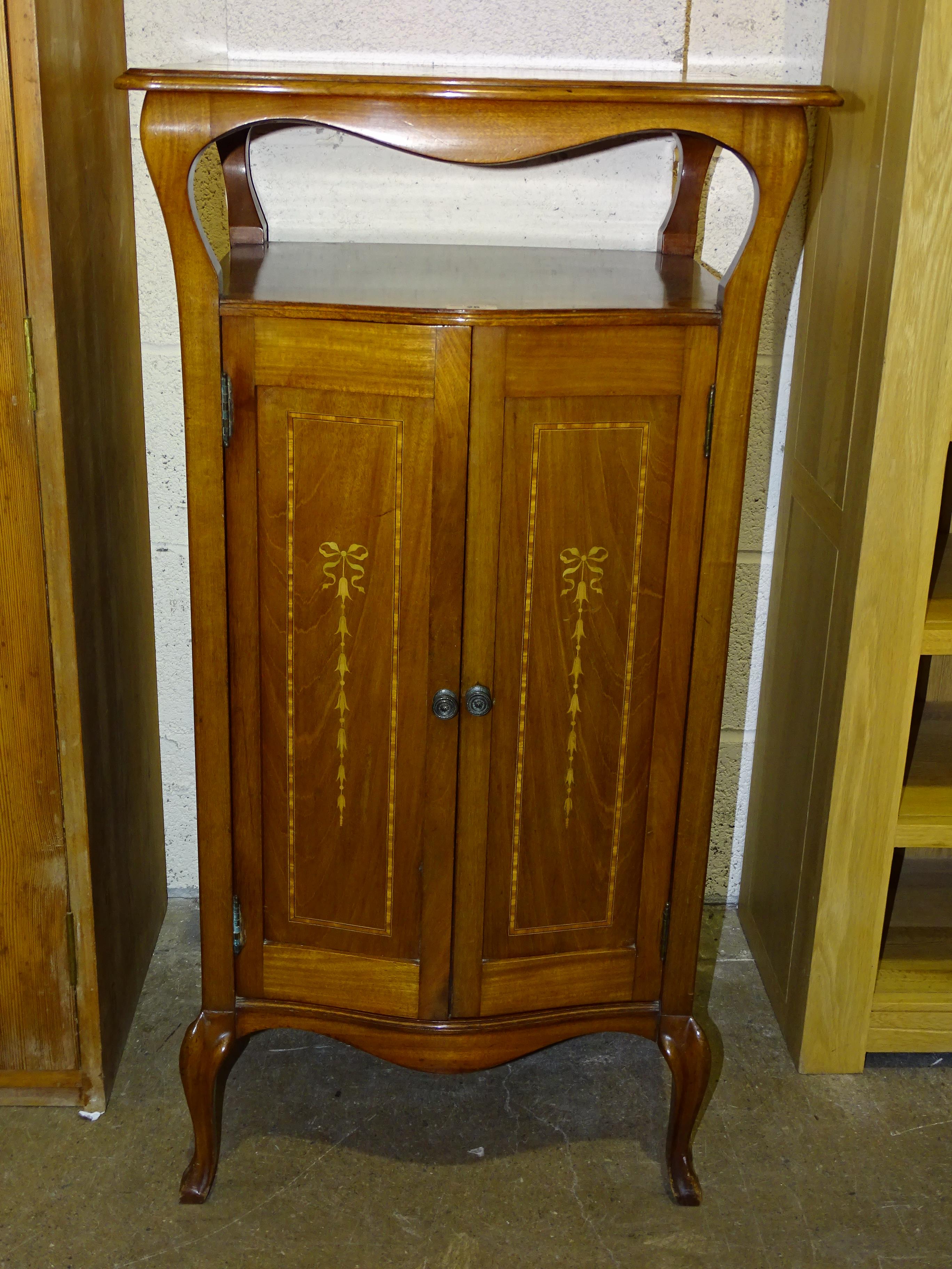 An Edwardian inlaid mahogany two-door music cabinet, 53cm wide, 101cm high.