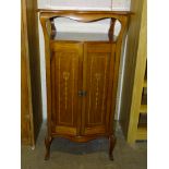 An Edwardian inlaid mahogany two-door music cabinet, 53cm wide, 101cm high.