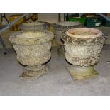 A set of four cast concrete campana-shaped garden planters, 37cm diameter, 39cm high (one with