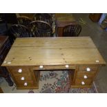 A mainly pitch pine panel knee-hole desk, having a central drawer and six pedestal drawers, 150cm