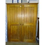 A pitch pine two-door storage cupboard, 110cm wide, 148cm high, a small stripped pine wash stand,