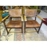 Two oak-framed armchairs with embossed leather-studded backs and seats, (2).