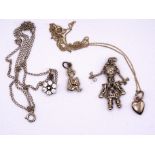 A 9ct gold articulated doll pendant, a small 9ct gold heart pendant on chain and other items,