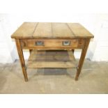 A rustic finish pine kitchen/side table having a single drawer and pot board, on square tapered