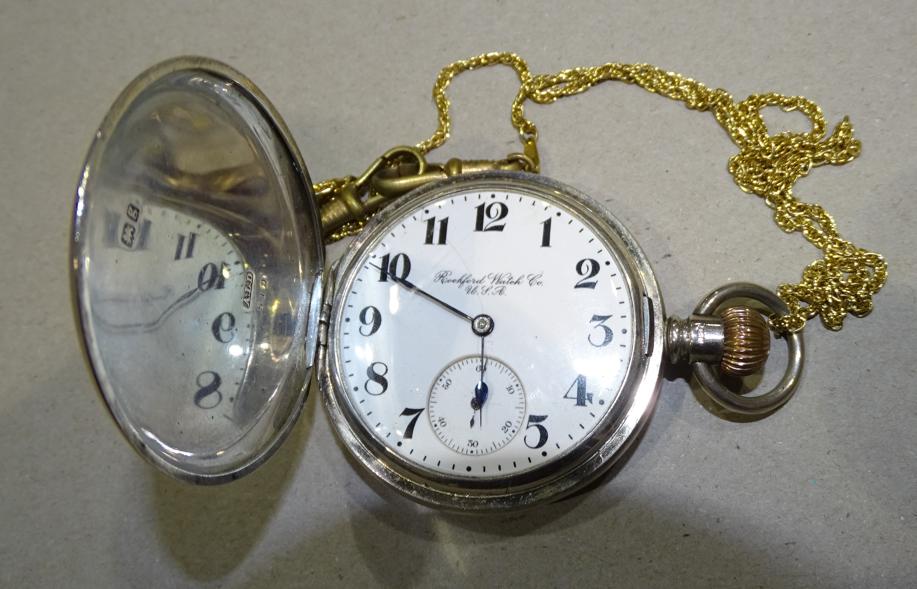 A silver hunter-cased keyless pocket watch, the white enamel dial signed Rockford Watch Co. USA, the
