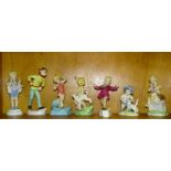 A collection of seven Royal Worcester figurines: 'January' 3452, 'April' 3416, (a/f, crack through