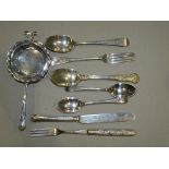 A silver bright-cut christening spoon and fork, London 1880, a white metal tea strainer and other