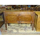 A mahogany low sideboard in the Chippendale taste, decorated with fretwork and foliate carving, on