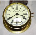 A Sestrel brass bulkhead ships clock, the dial marked Henry Browne & Son Ltd, Barking & London, 18cm