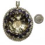 A very large white metal pendant set a round-cut smoky quartz of approximately 277cts, (44mm