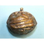 A silver-plated purse in the form of a walnut, with gilt interior, 6cm.