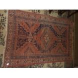 Three worn Oriental rugs.