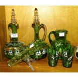A pair of late-19th century green glass decanters with coloured enamel floral decoration and clear