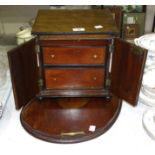 A mahogany table-top work box, the hinged lid above two doors opening to reveal two drawers, 29cm