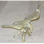 A large brass eagle perched on a branch with wings outstretched, 48cm high, wingspan 68cm.
