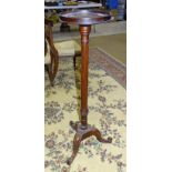 A 19th century mahogany torchère, the circular top, 28.5cm diameter on reeded column and triform