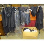 A collection of mourning clothing including dark suits, overcoats, etc, various sizes, formerly used