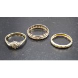 A 9ct gold cluster ring set diamond points, a 9ct gold wedding band and a 9ct gold eternity ring set