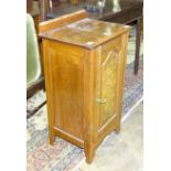 An Edwardian walnut pot cupboard fitted with a single door, 43.5cm wide.