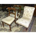A Victorian upholstered nursing chair on turned front legs and two Victorian dining chairs, (one