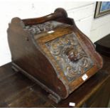 A carved oak coal box with lion mask lid, 36cm wide, 35cm high, 47cm deep.