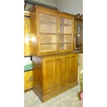 An early-20th century oak bookcase, the pair of glazed doors above a pair of panelled doors, 130cm