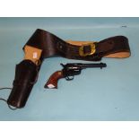 A replica Phoenix Arms America Western revolver, in leather holster and belt.