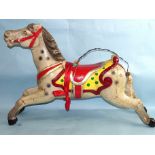 A painted fibreglass carousel horse, 66cm high, 94cm long.