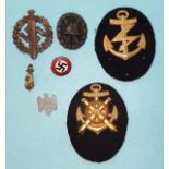 A German SA sports badge (pin lacking), a German wound badge, a WWII German Kriegsmarine Engineer
