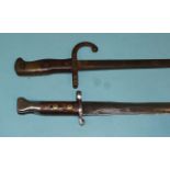 A Belgian 1876 pattern sword bayonet with bronze and iron fittings and wood grips, the single-edge