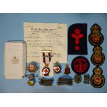 A British Red Cross Society three years service medallion and various metal and cloth badges for VAD