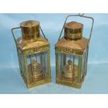 Two vintage brass 20th century oil lamps with hinged tops, four glazed side panels and carrying