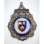 A pierced silver Chairman's jewel of circular form framed by leaves and berries, with central enamel