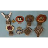 A collection of eight car badges, including 'AA' no.V277890, 'Yorkshire', 'Royal Air Force', 2x '