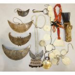 A collection of Oceanic items: a turtle fish hook, a comb, marine ivory necklaces and pendants.