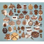 Approximately fifty various military badges, shoulder titles, etc.