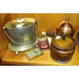 A copper tobacco jar and cover, 19cm high, an oak tobacco jar and cover, a brass embossed matchbox