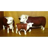 A Beswick Hereford bull, cow and calf, (all gloss), (3).